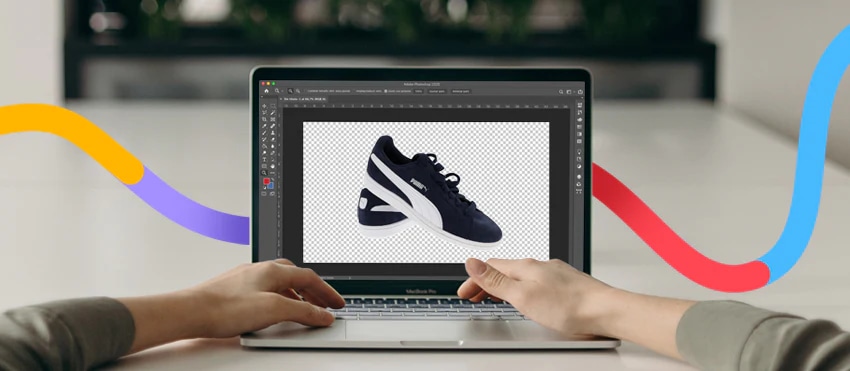 Hands editing a black and white sneaker image on a laptop using Photoshop, with colorful design accents.