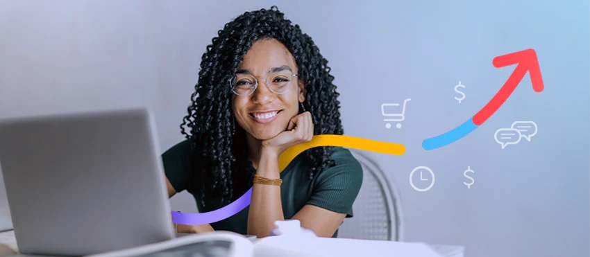 Smiling woman at laptop with overlay icons of upward arrow, shopping cart, and dollar signs indicating digital sales growth.
