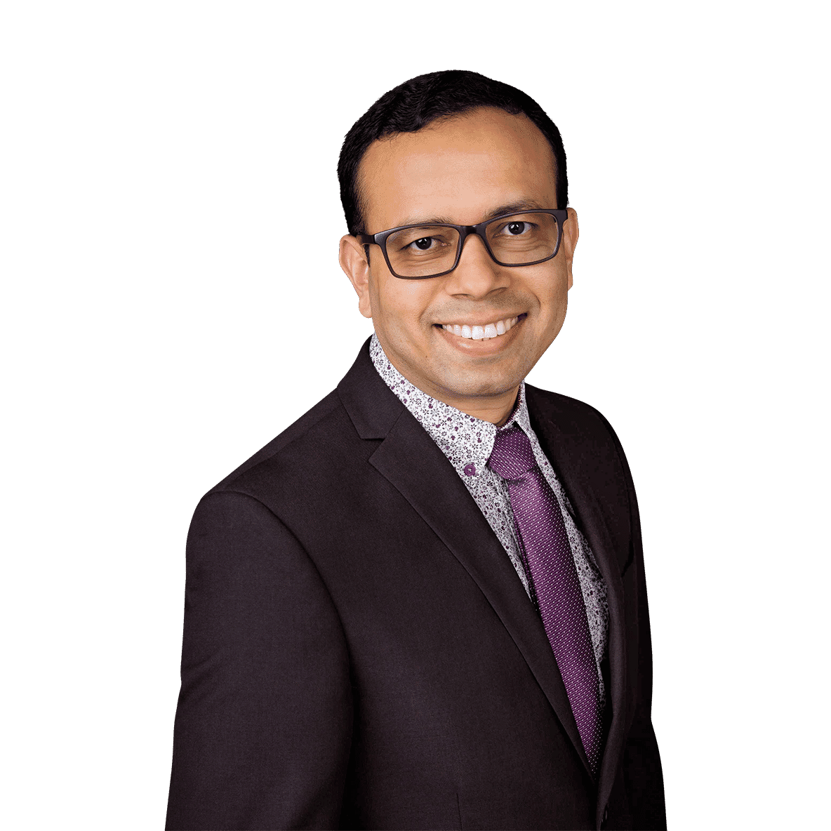 Smiling chief executive officer in dark suit, floral shirt, purple tie, and glasses, posed professionally, edited